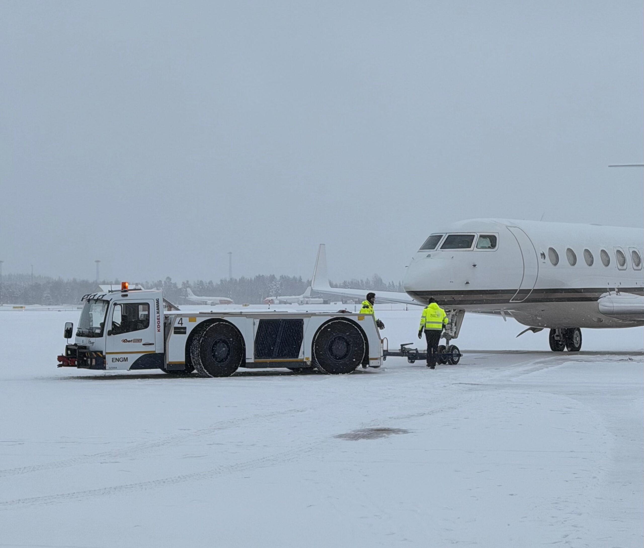 Snowy day in the Nordics, with a plane getting assistance from our truck