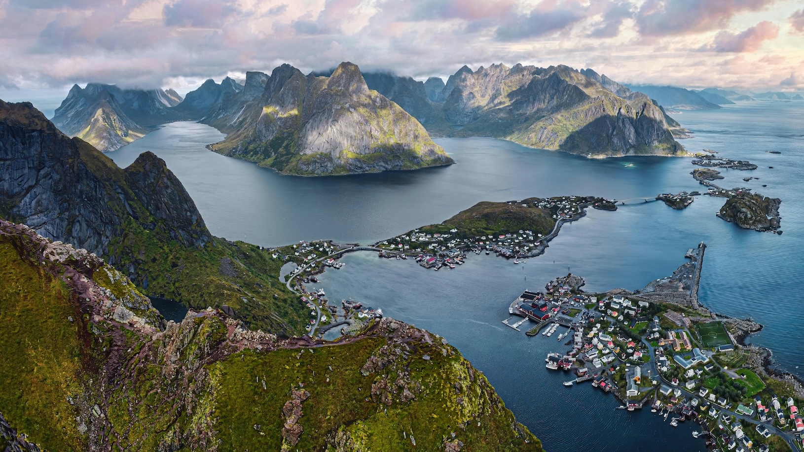 Lofoten islands from above, looking at mountains, sea and villages on the flatter islands.